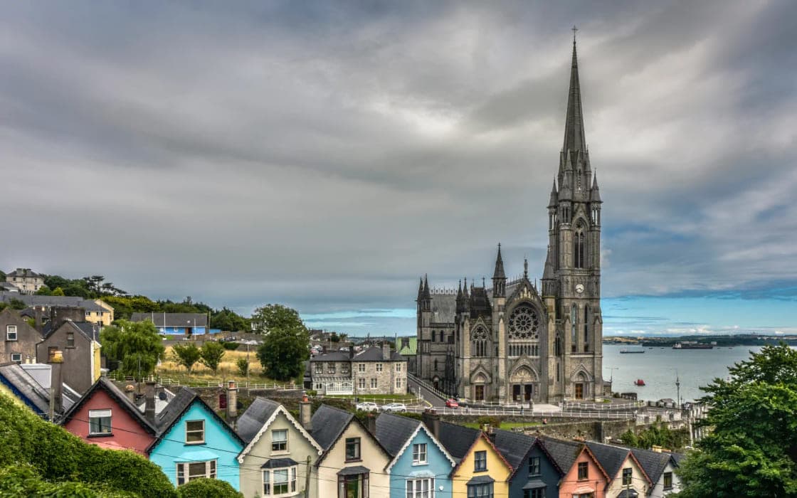 Colourful terraced houses below St Colman's Cathedral at Cobh, County Cork