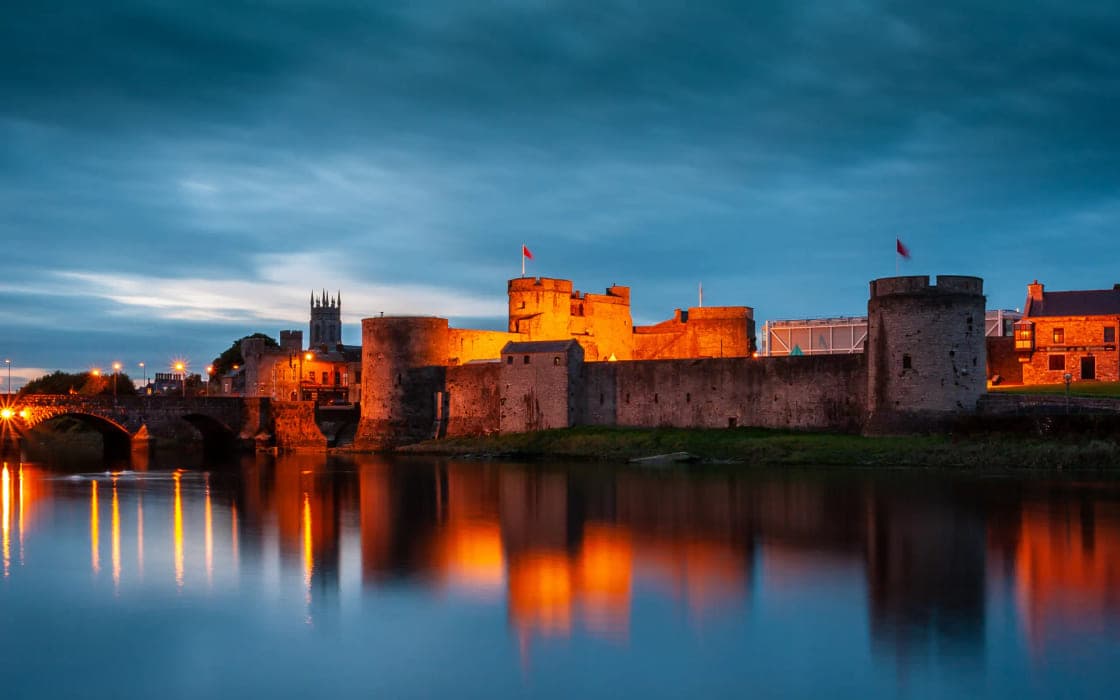 King John's Castle floodlit on the banks of the River Shannon in Limerick