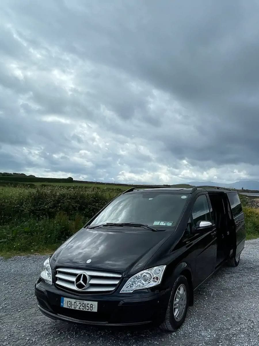 A TransferCabs minivan parked on the coast road to Dingle, County Kerry